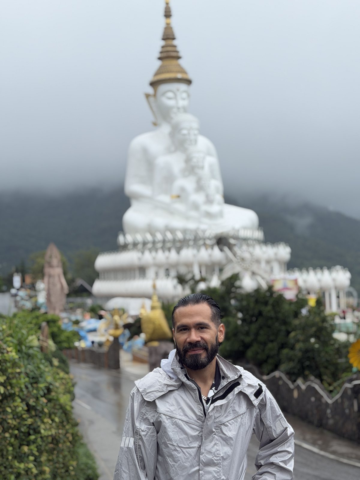 Josh in front of the five white Buddha images at Wat Phra That Pha Sorn Kaew.