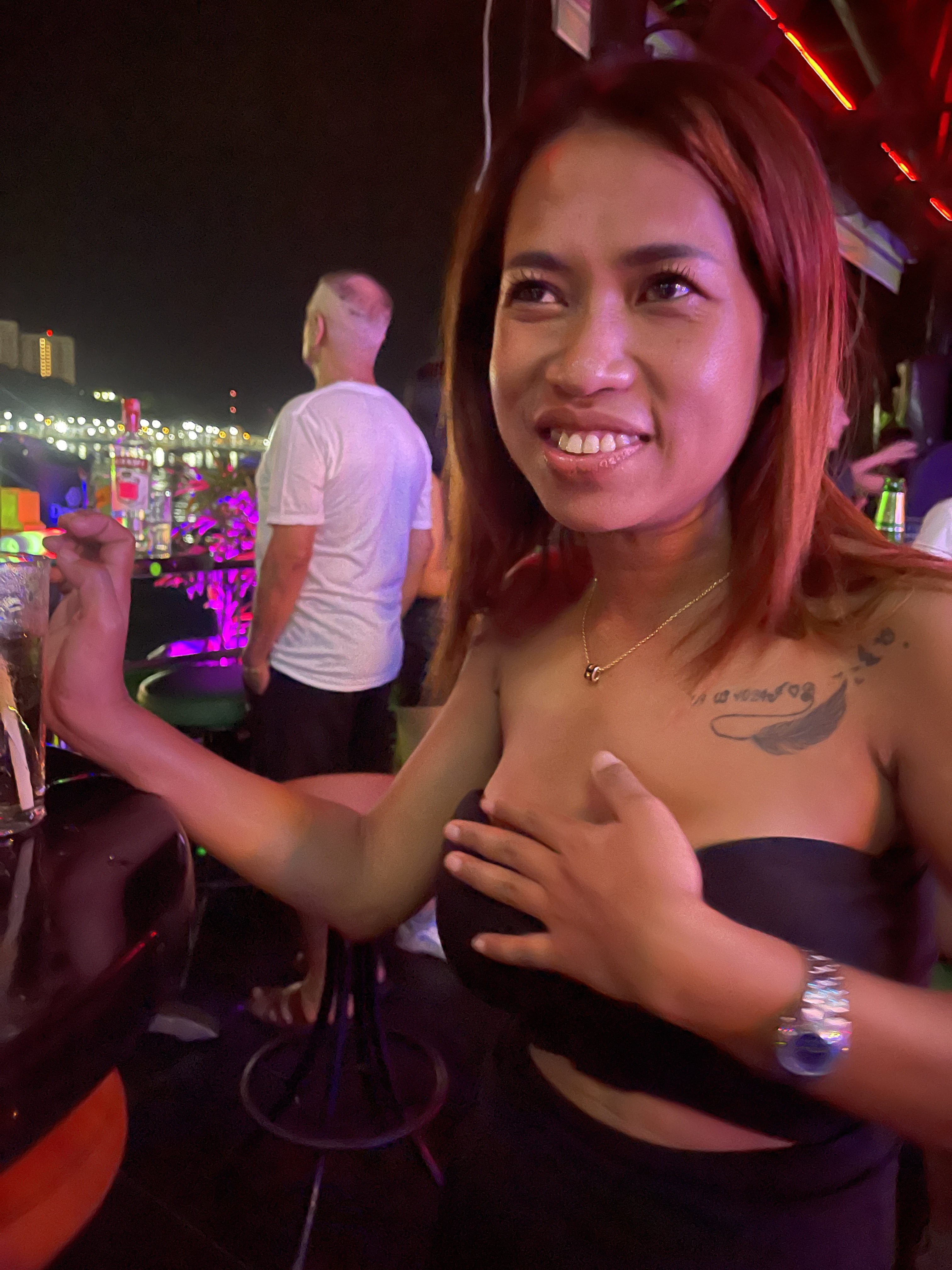 Kib smiling under colorful lights at night.